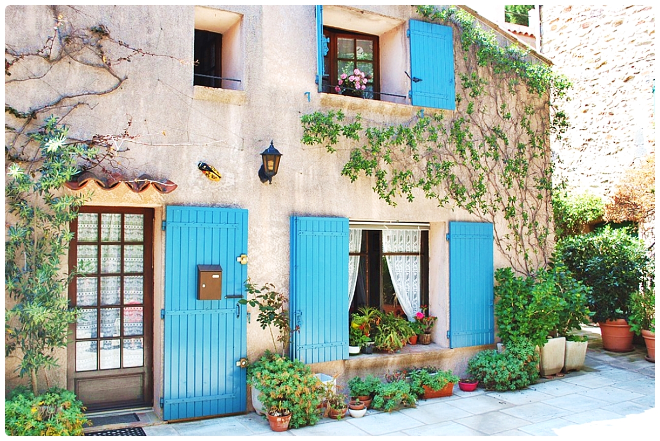 Solve Lovely White Stucco Cottage with Sky Blue Door and Window
