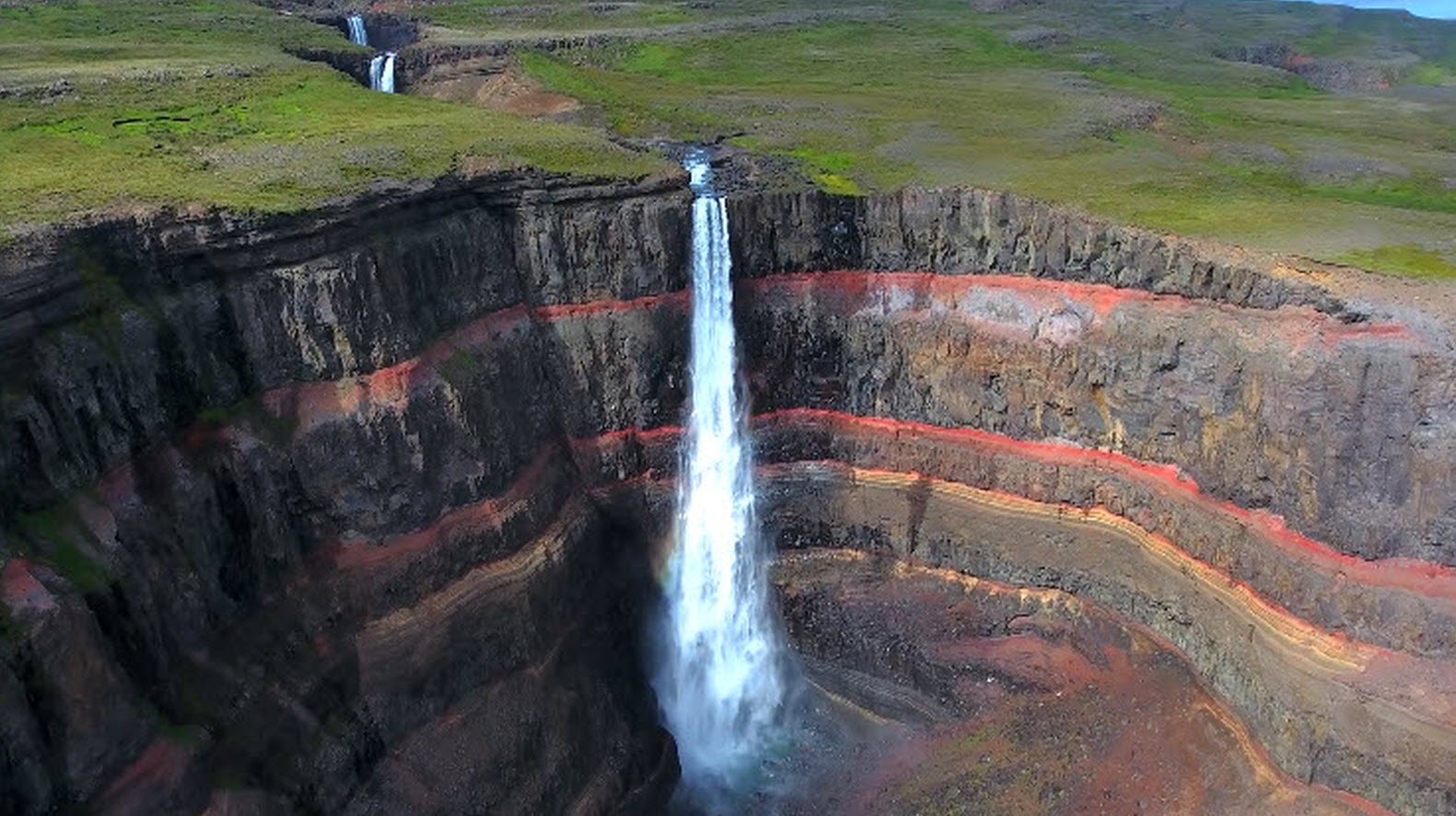 Solve Amazing red rock behind the waterfall jigsaw puzzle online with ...