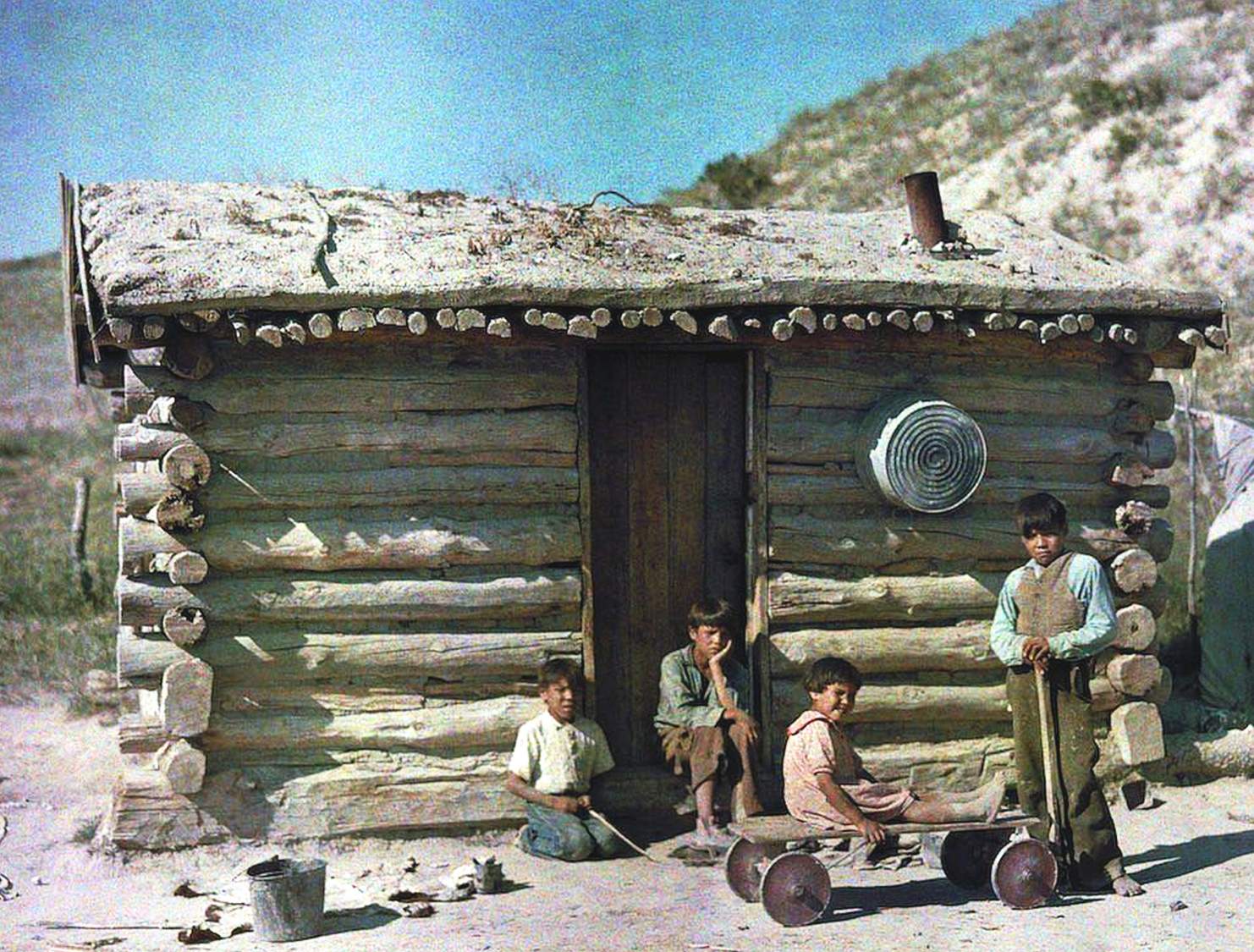 Solve Native American children outside a sod roof house jigsaw puzzle