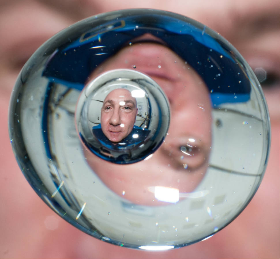 Solve Dutch astronaut Andre Kuipers refracted in a floating water ...
